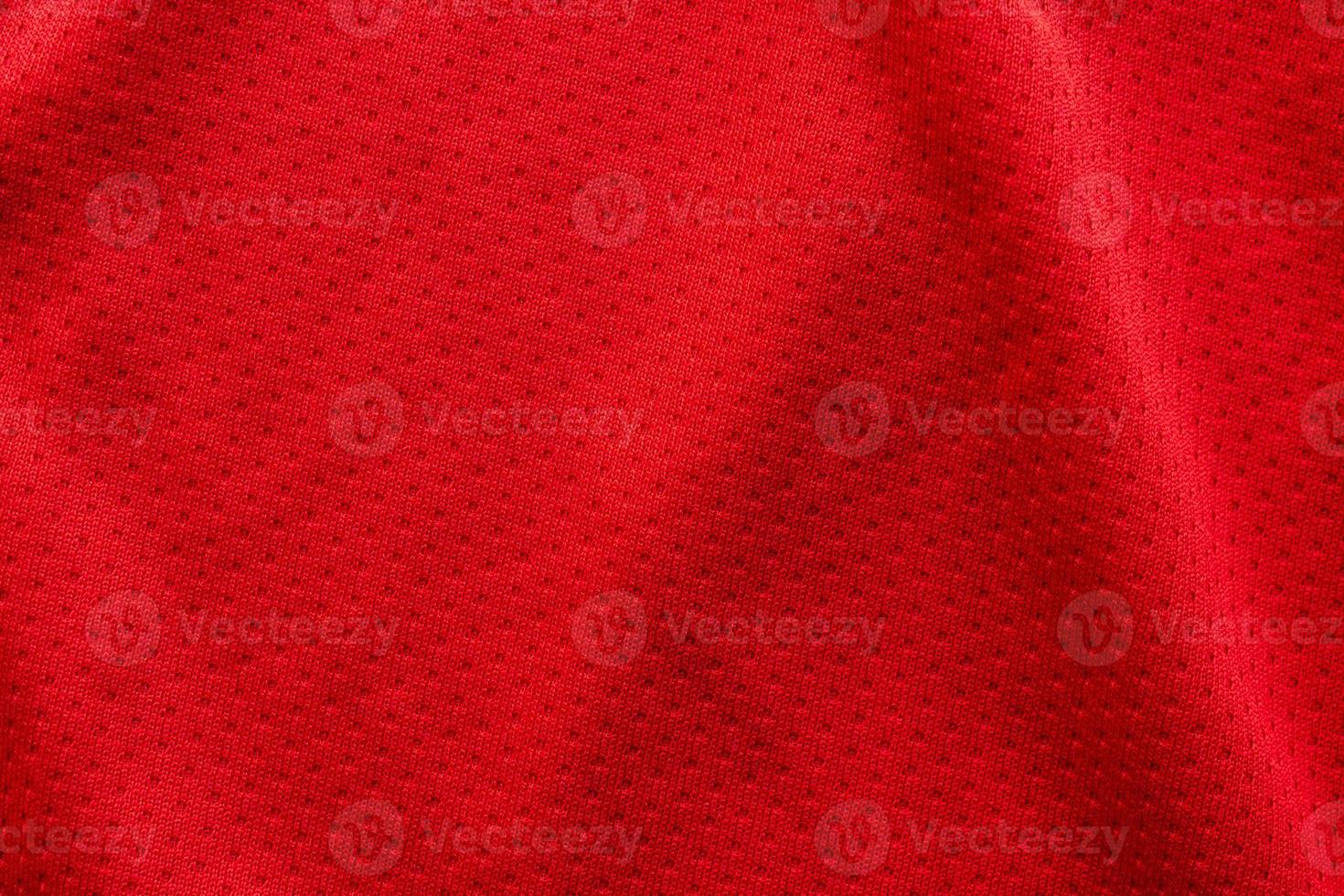 Red fabric sport clothing football jersey with air mesh texture background photo