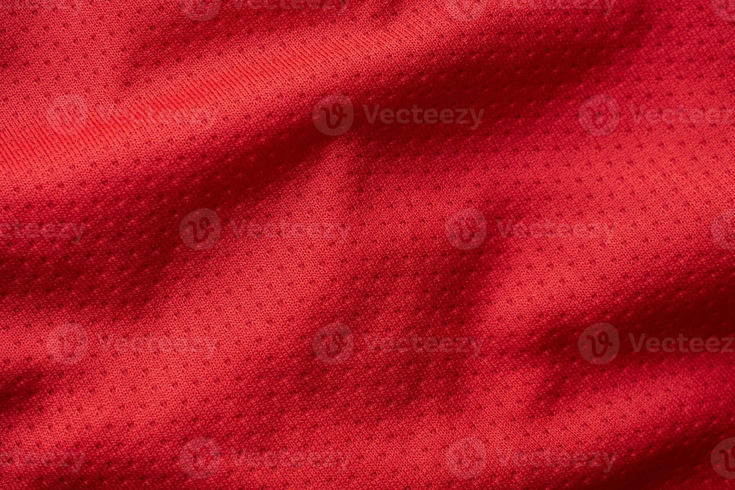 Red fabric sport clothing football jersey with air mesh texture background photo