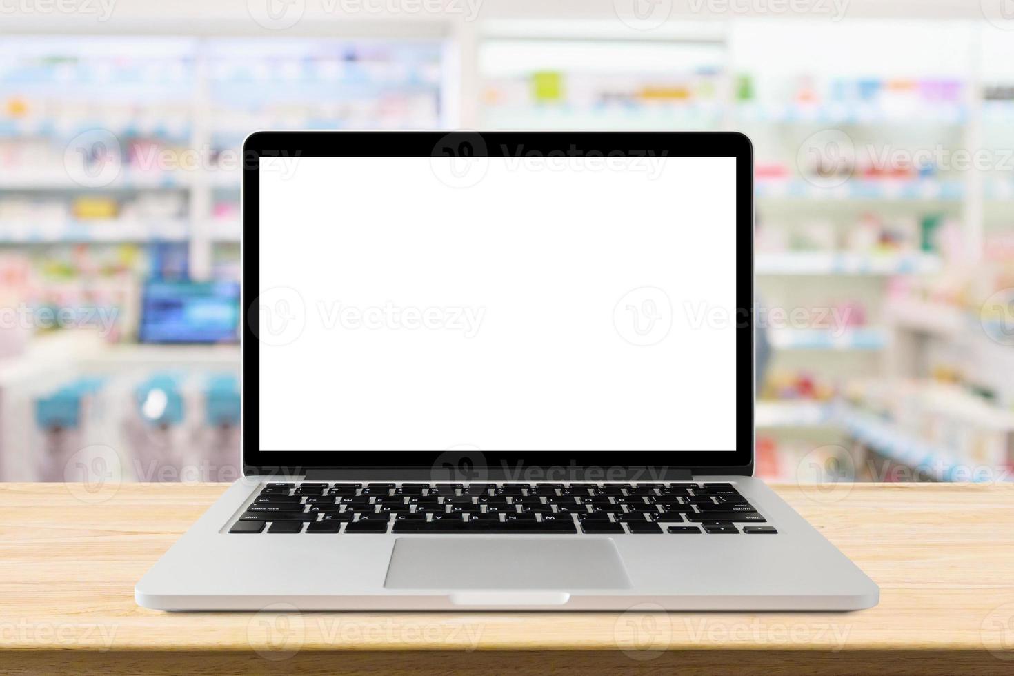 Laptop computer blank screen on pharmacy counter drugstore shop interior photo