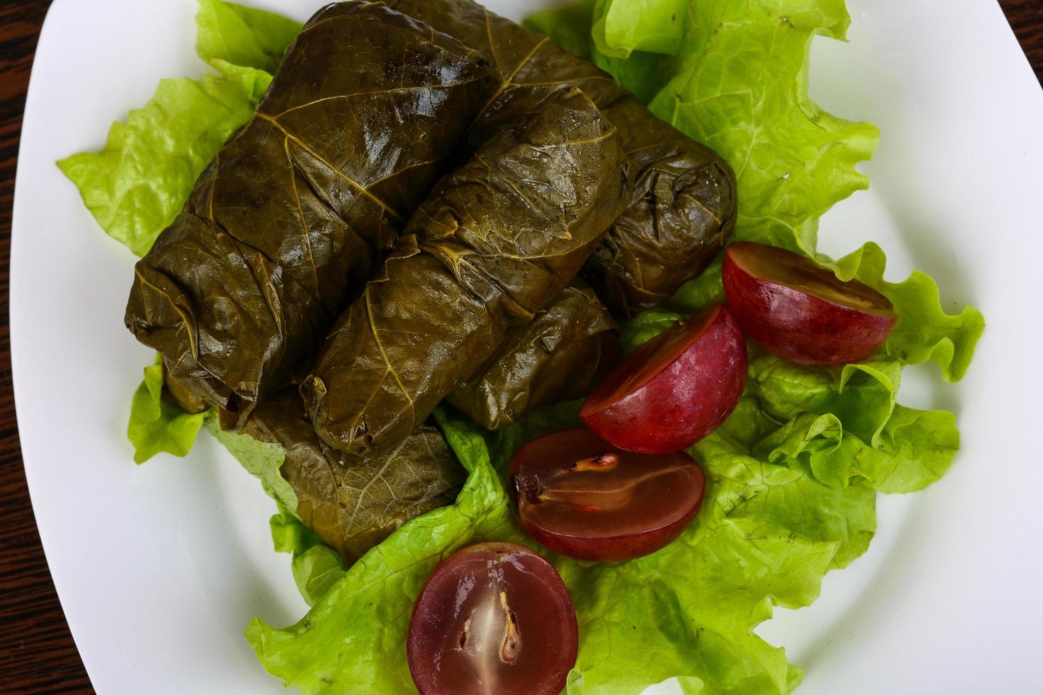 Dolma on the plate and wooden background photo