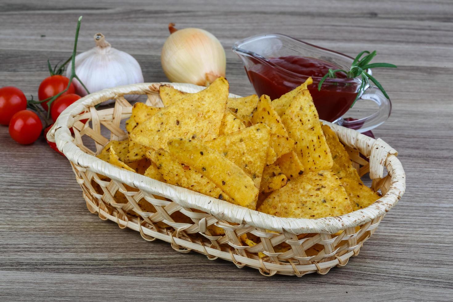 Nachos in a basket on wooden background 12474421 Stock Photo at Vecteezy