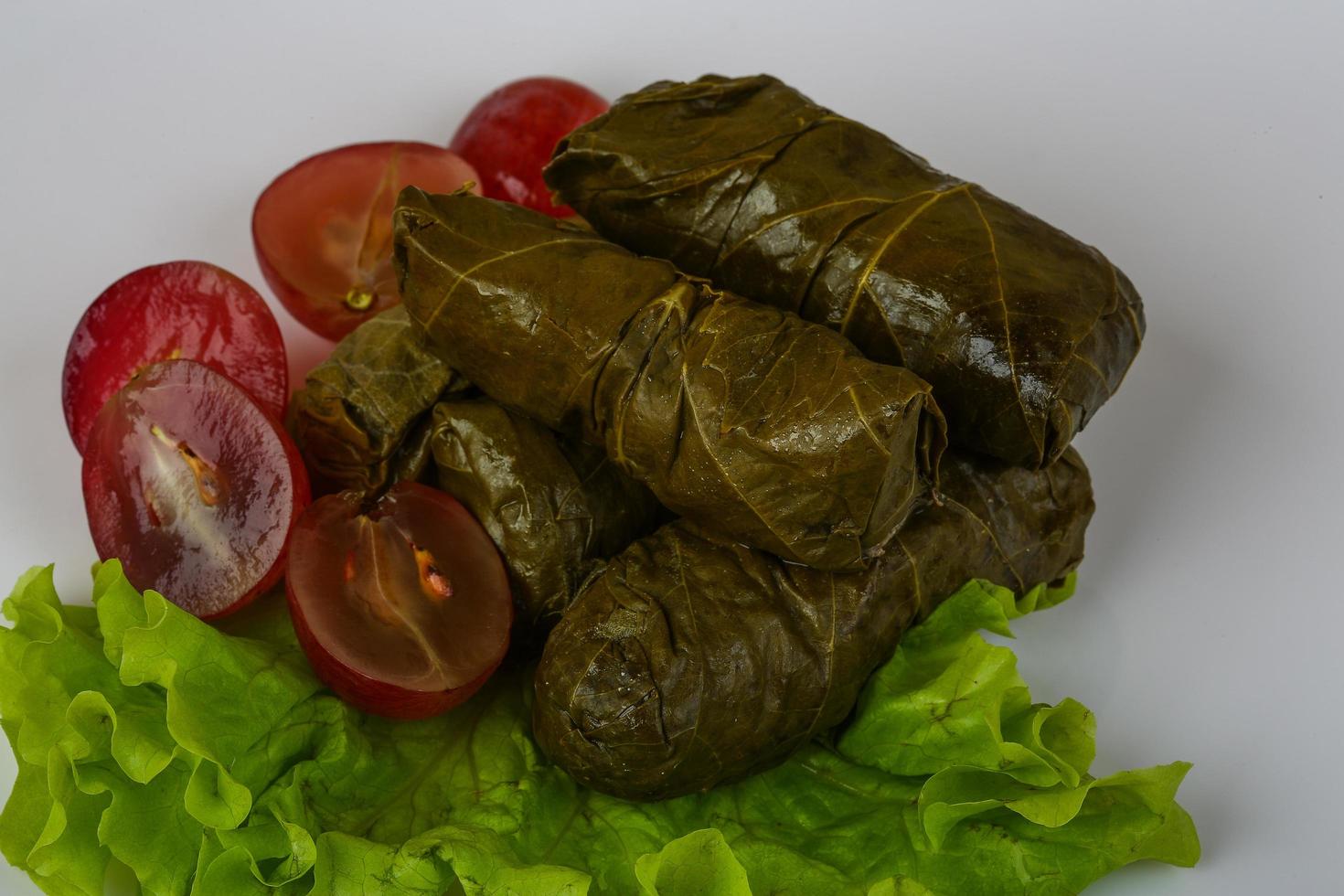 Dolma on the plate and wooden background photo