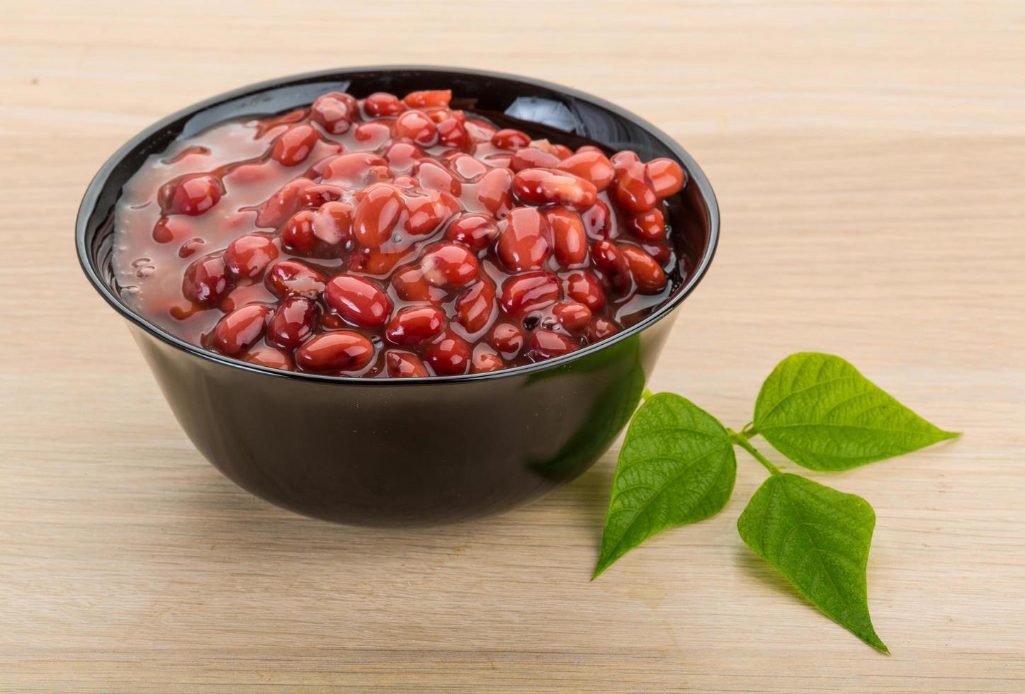 Red beans in a bowl on wooden background photo