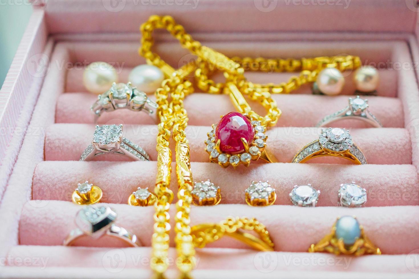 Gold and silver diamond gemstone sapphire ring necklaces and pearl earrings in luxury jewelry box photo