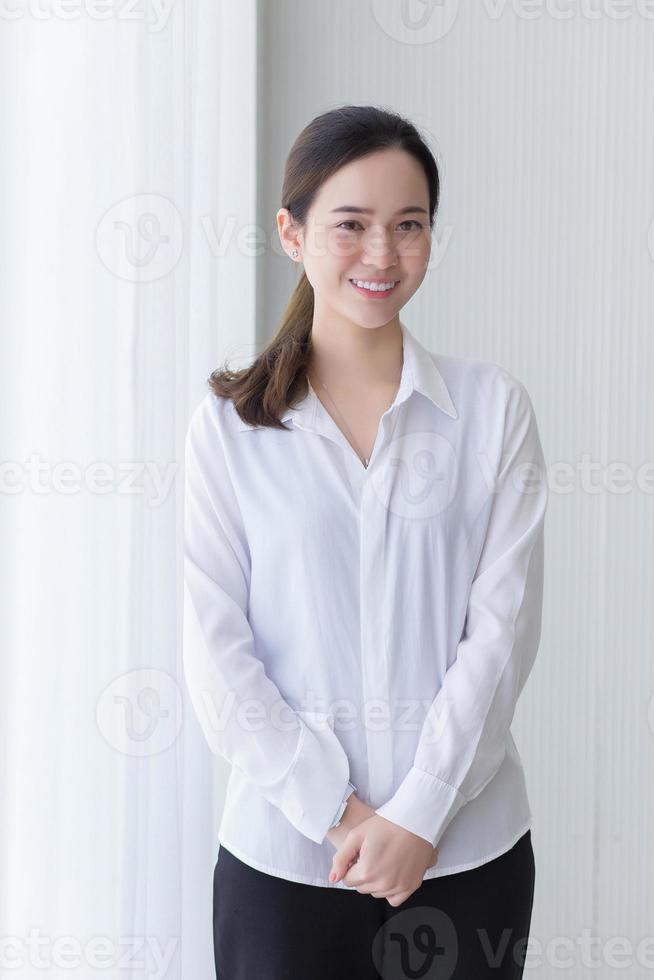 Asian beautiful woman has black long hair in white shirt. photo