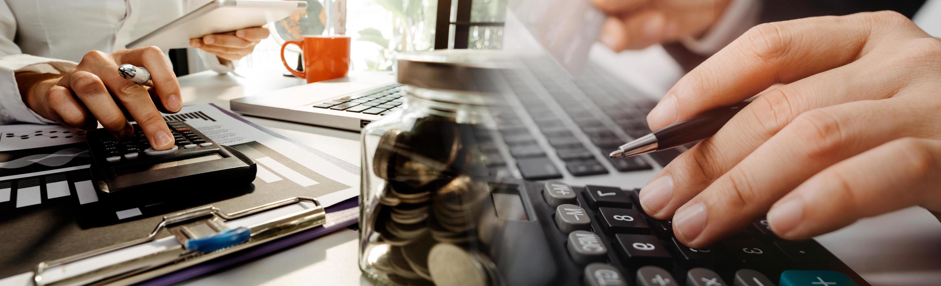 Business accounting concept, Business man using calculator with computer laptop, budget and loan paper in office. photo