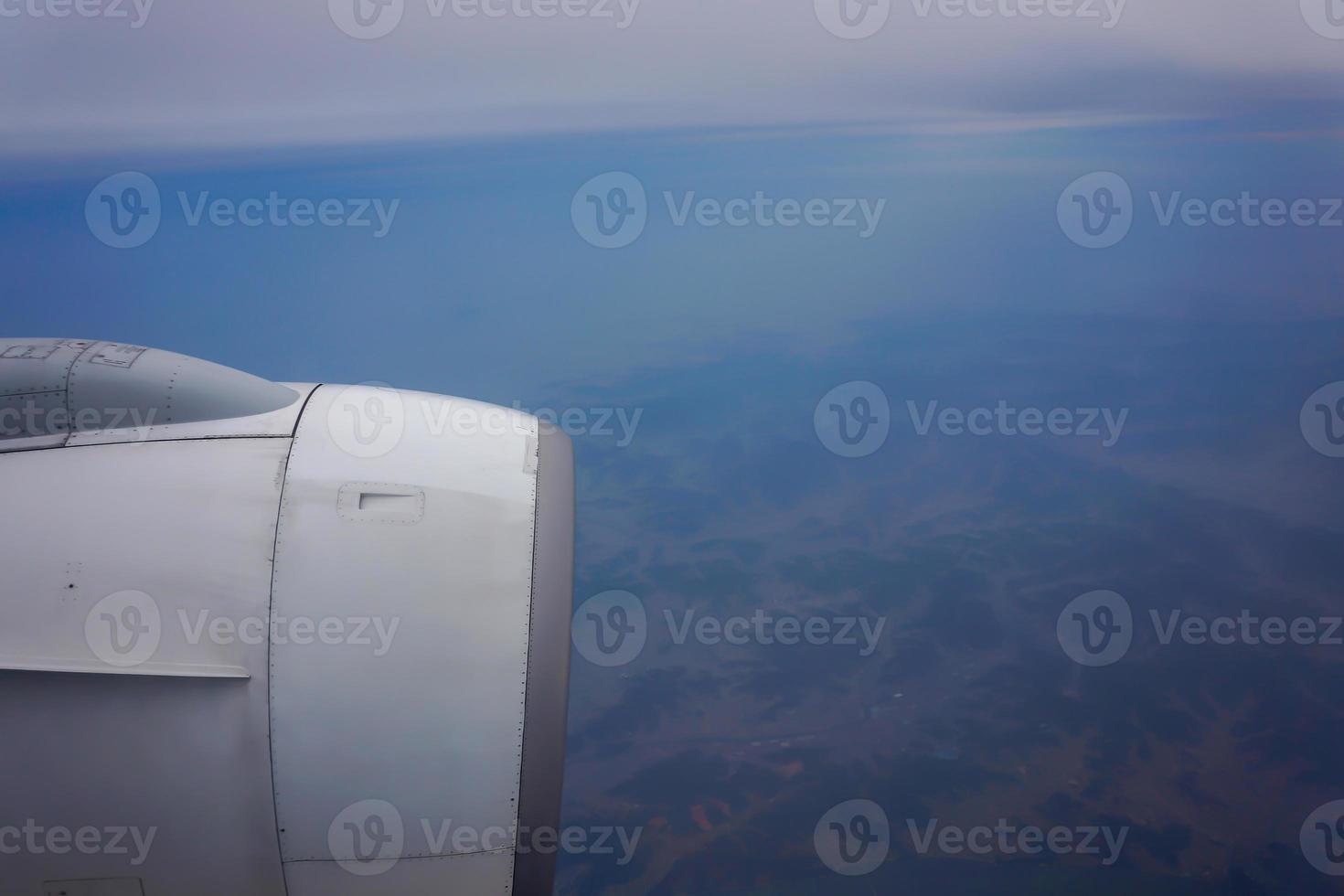 jet plane window sky view with machine wing in the morning. photo