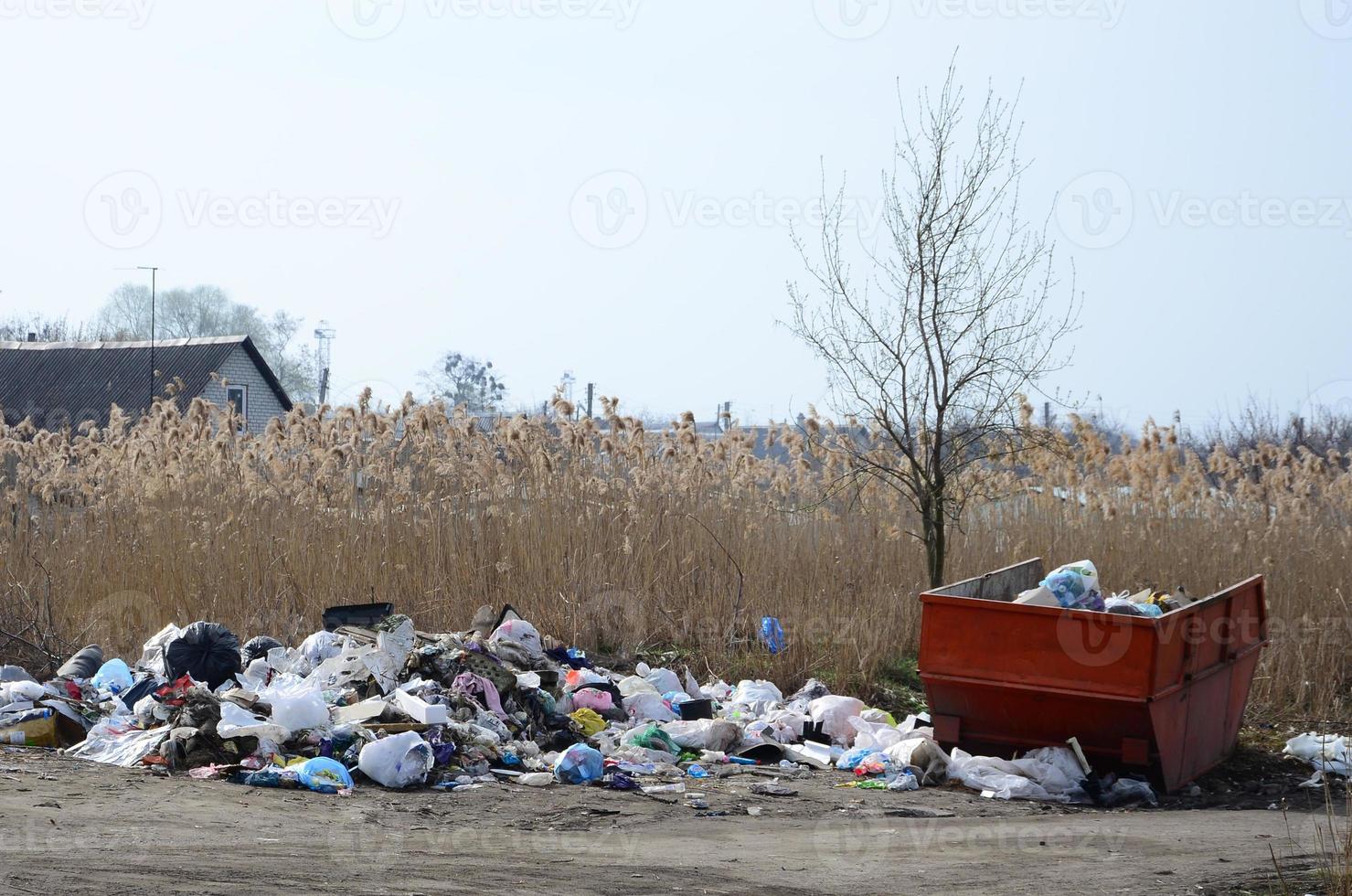The garbage can is packed with garbage and waste. Untimely removal of garbage in populated areas photo