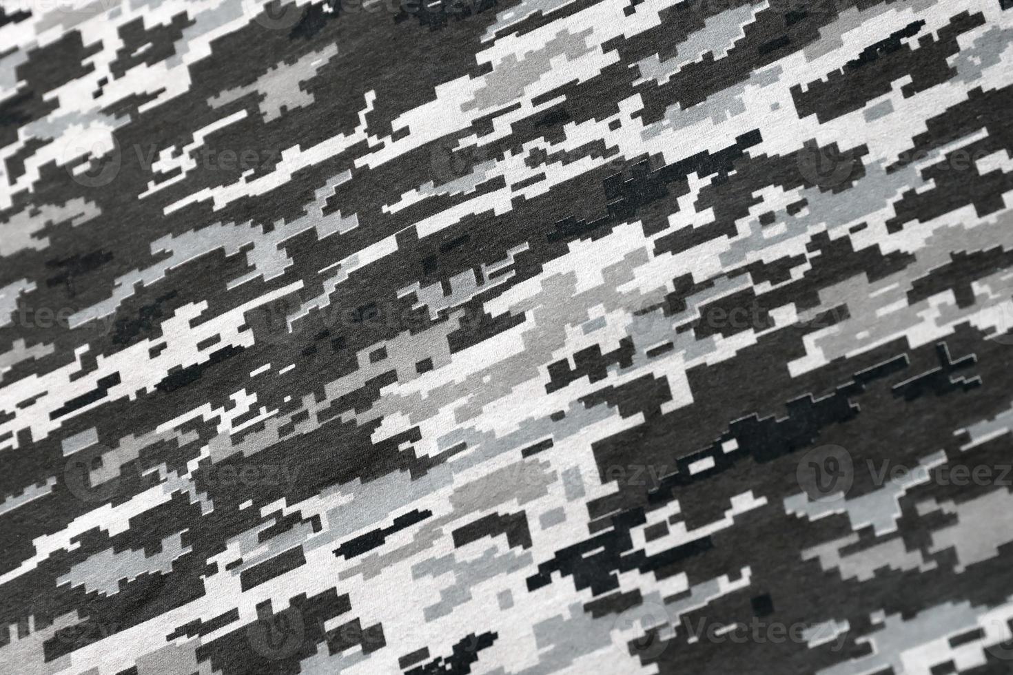 Fabric with texture of Ukrainian military pixeled camouflage. Cloth with camo pattern in grey, brown and green pixel shapes. Official uniform of Ukrainian soldiers photo