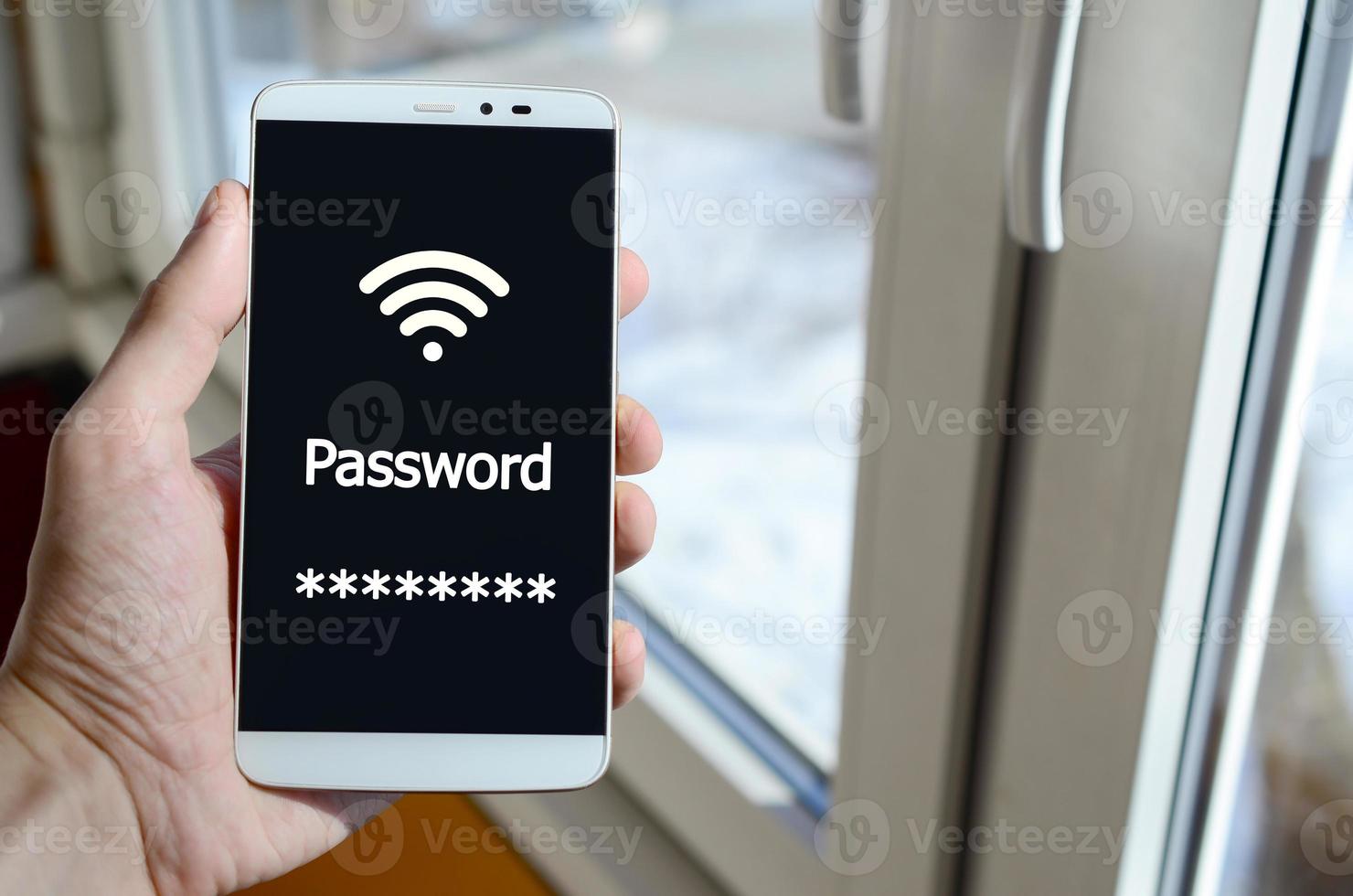 A person sees a white inscription on a black smartphone display that holds in his hand. Password photo