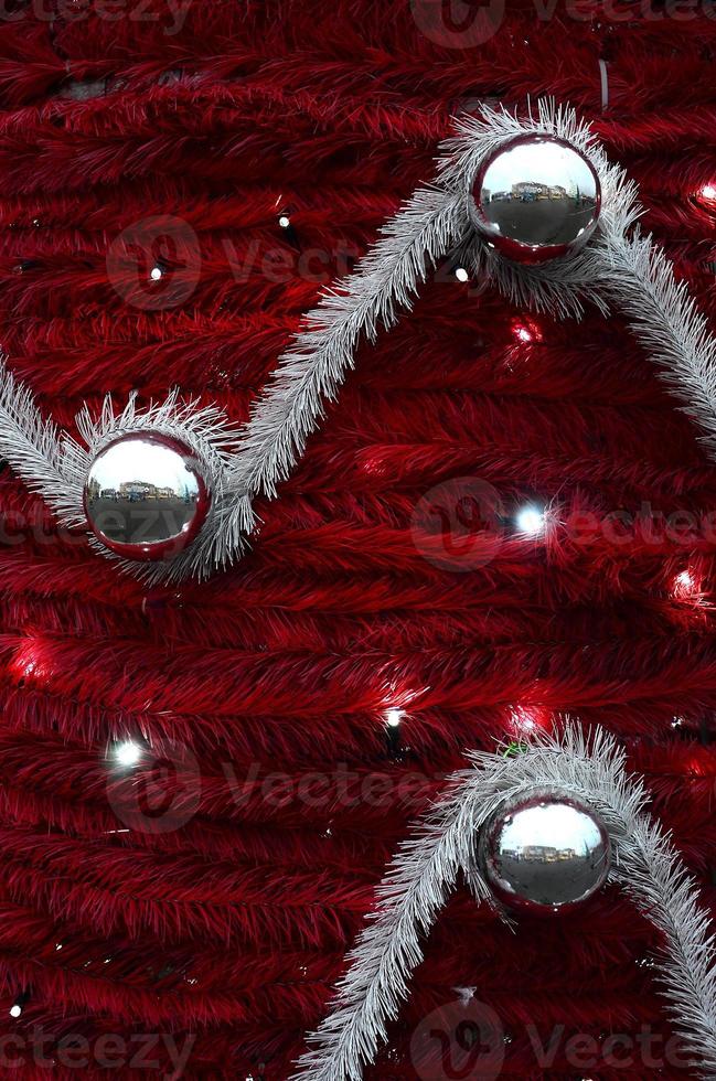 Texture of the wall decorated with New Year's fluffy ribbons and decorations in the form of glossy balls photo