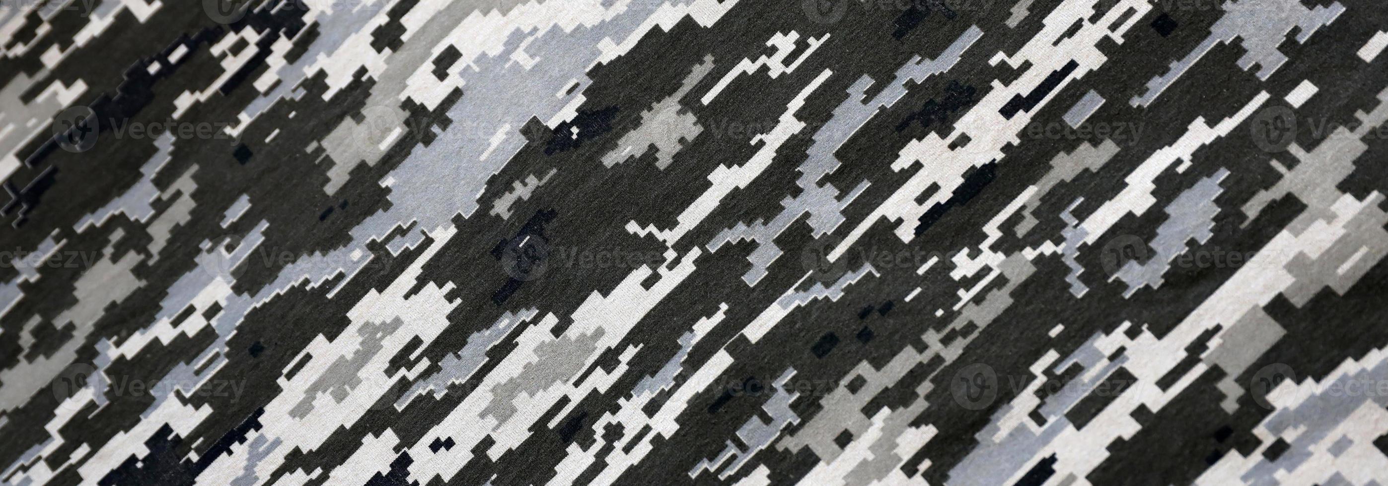 Fabric with texture of Ukrainian military pixeled camouflage. Cloth with camo pattern in grey, brown and green pixel shapes. Official uniform of Ukrainian soldiers photo