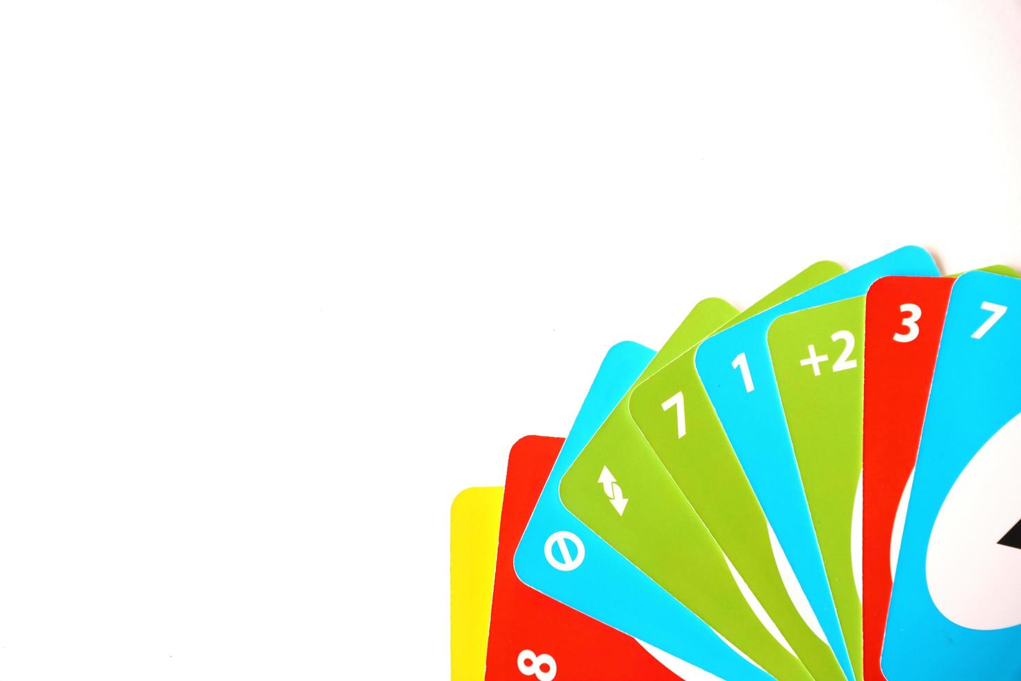 TERNOPIL, UKRAINE - MAY 15, 2022 Many colorful UNO game cards on white background. UNO is an American shedding-type card game that is played with a specially printed deck photo