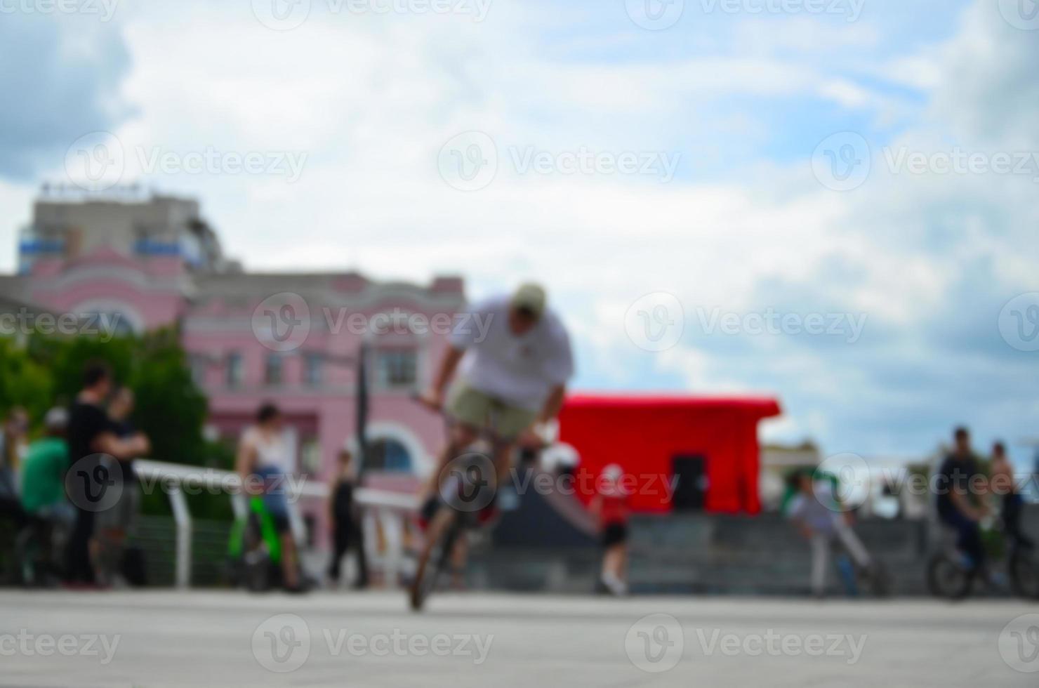 Defocused image of a lot of people with bmx bikes. Meeting of fans of extreme sports photo