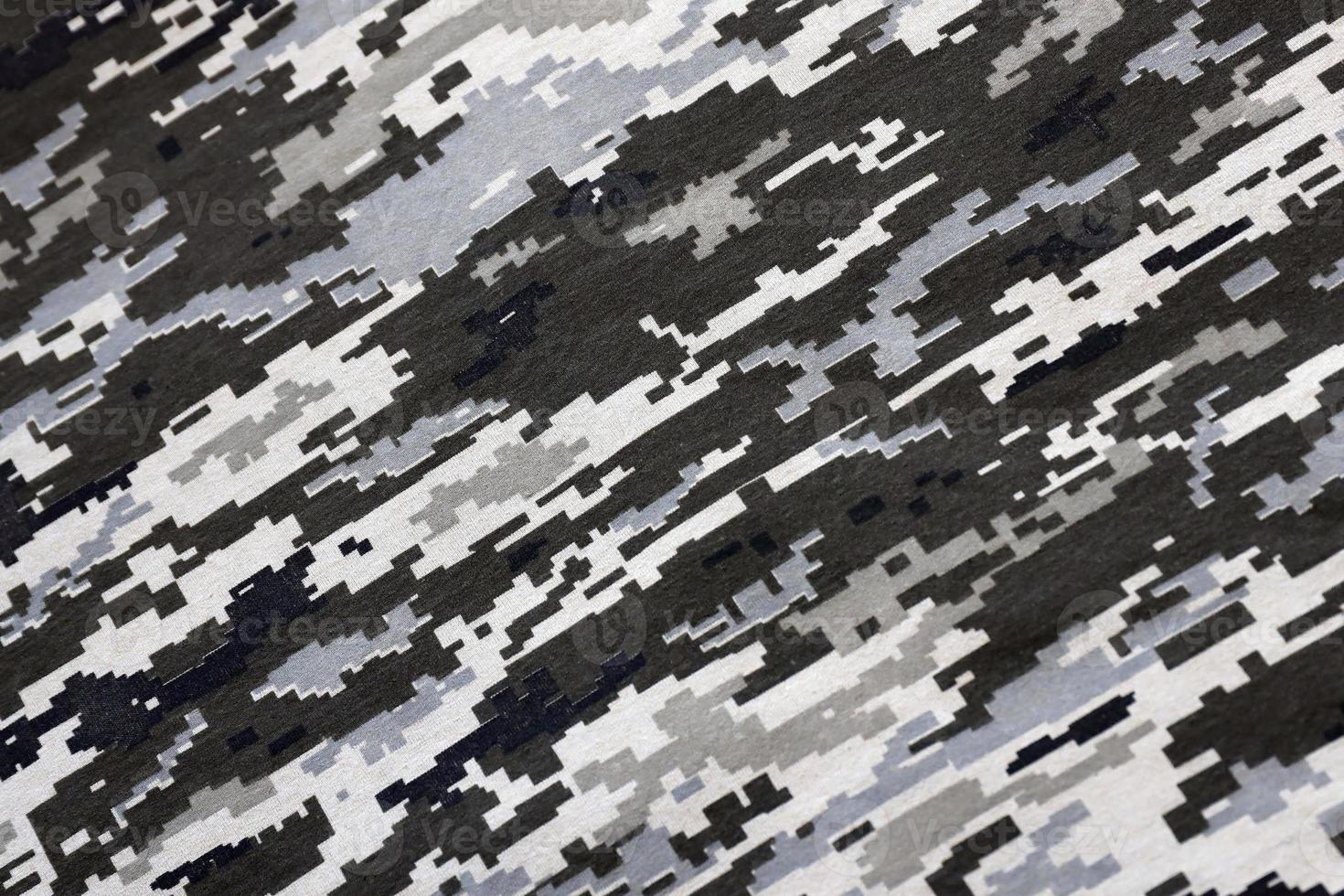 Fabric with texture of Ukrainian military pixeled camouflage. Cloth with camo pattern in grey, brown and green pixel shapes. Official uniform of Ukrainian soldiers photo