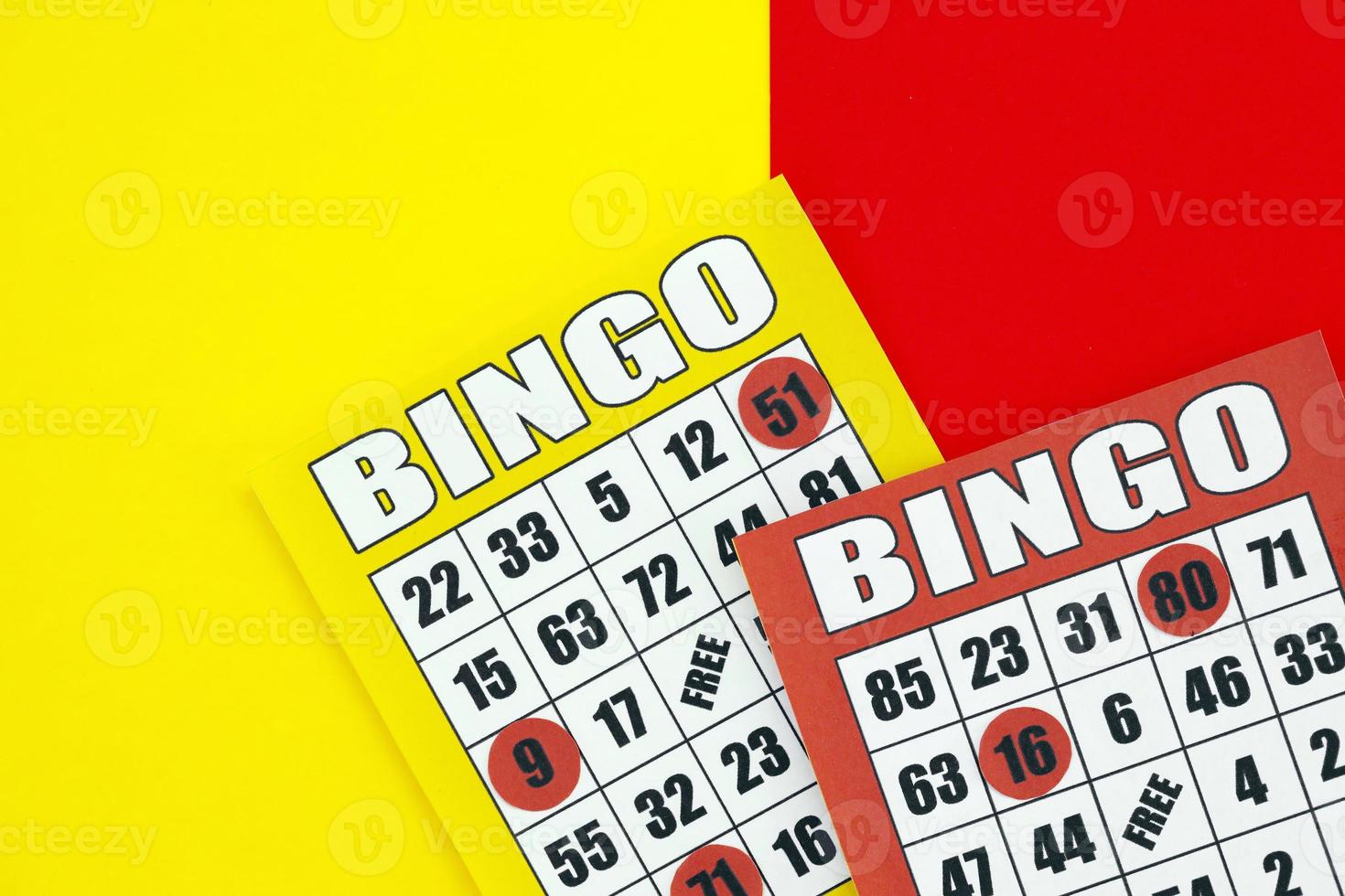 Yellow and red bingo boards or playing cards for winning chips. Classic US or canadian five to five bingo cards on bright background photo