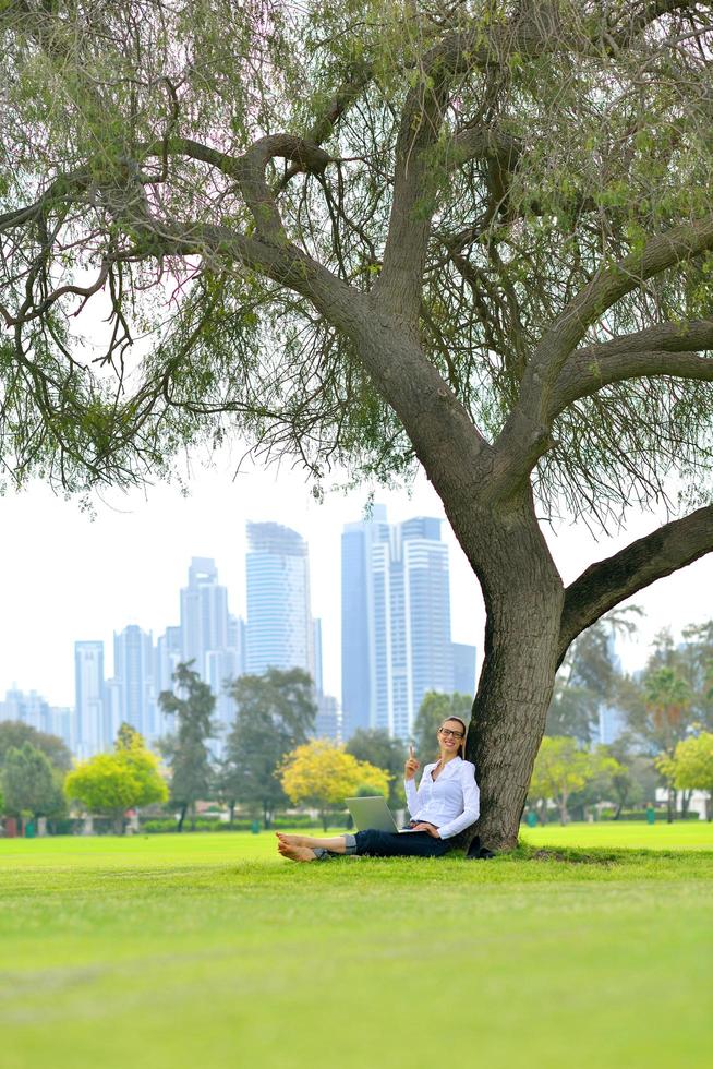 woman with laptop in park photo