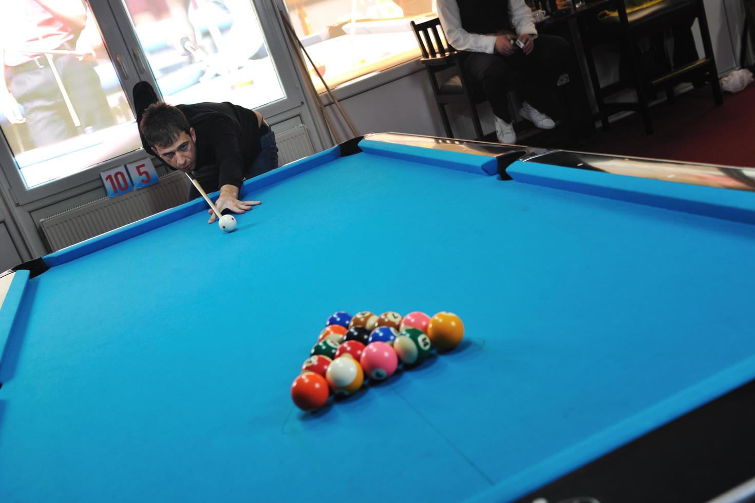 young man play pro billiard game photo