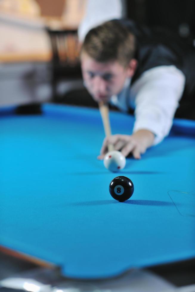 young man play pro billiard game photo