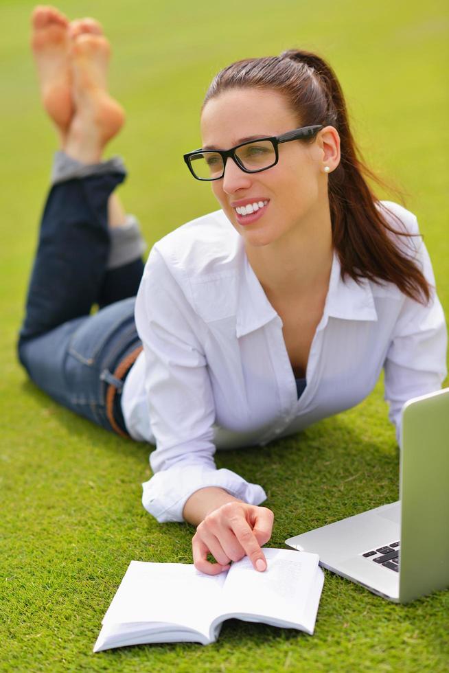 woman with laptop in park photo