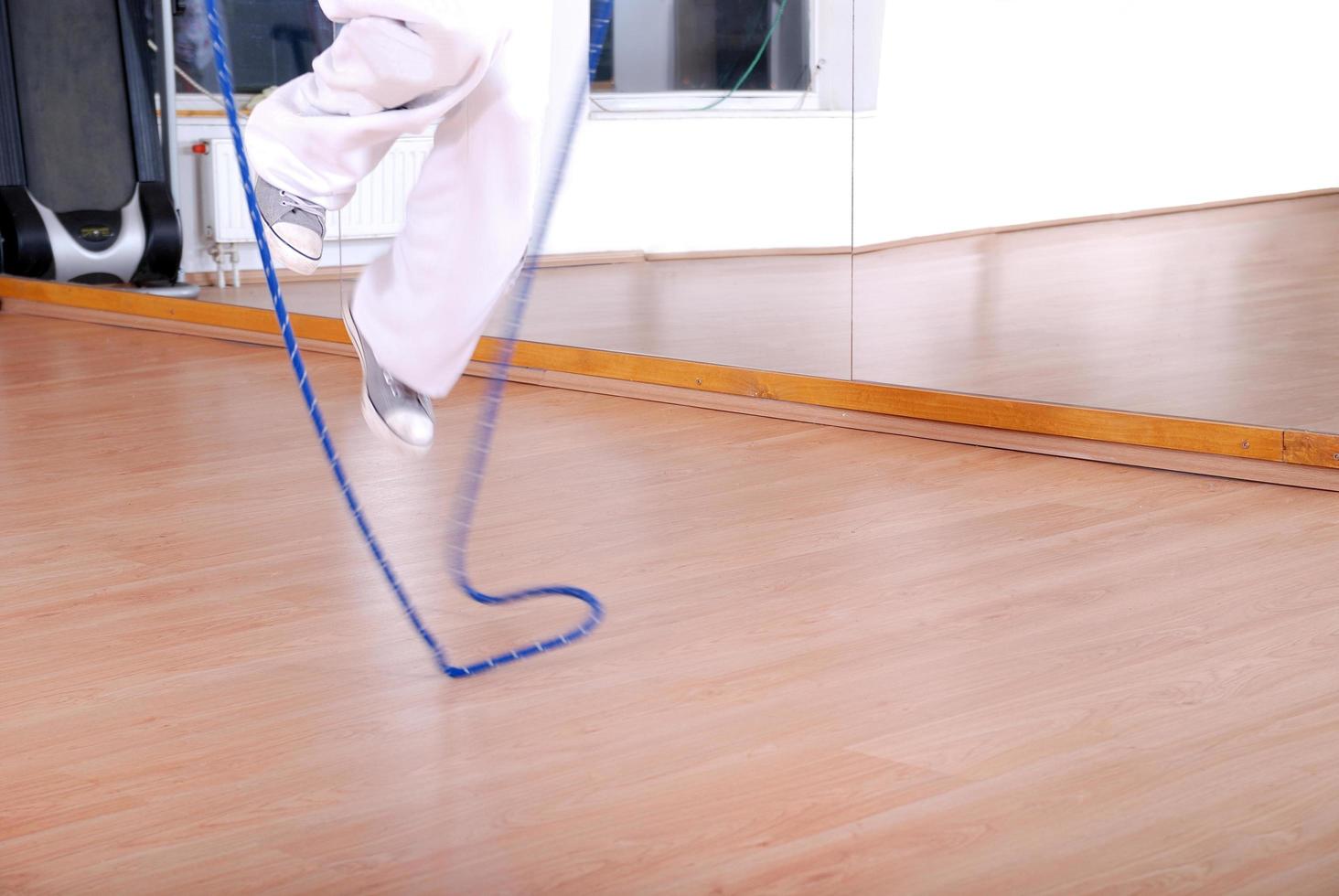 .young man using a jump rope photo