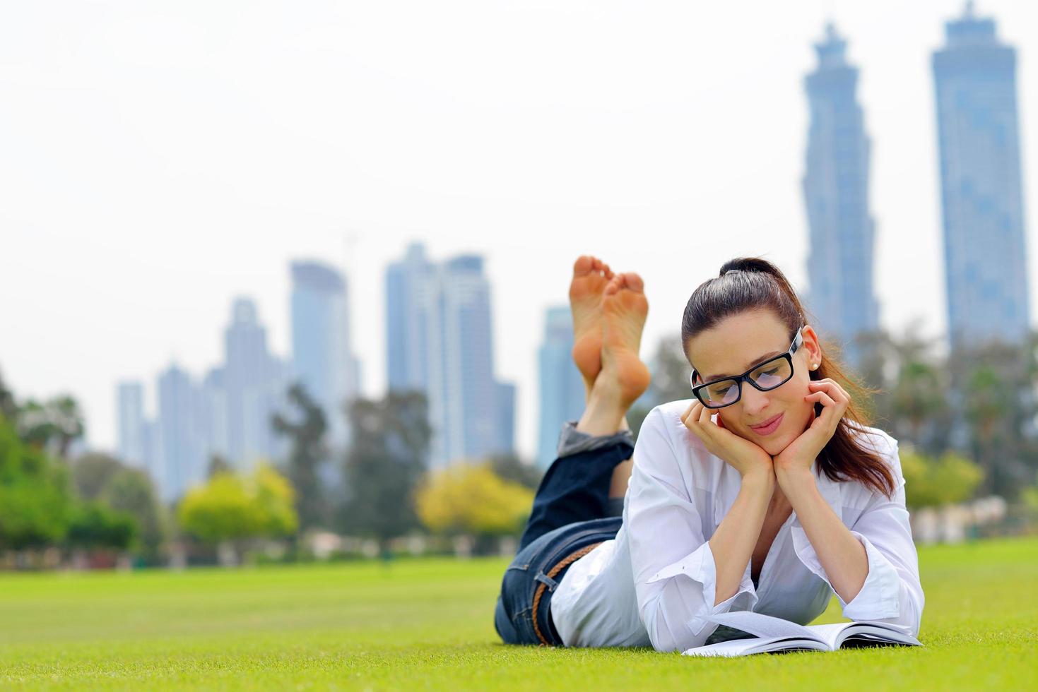 Young woman reading a book in the park photo