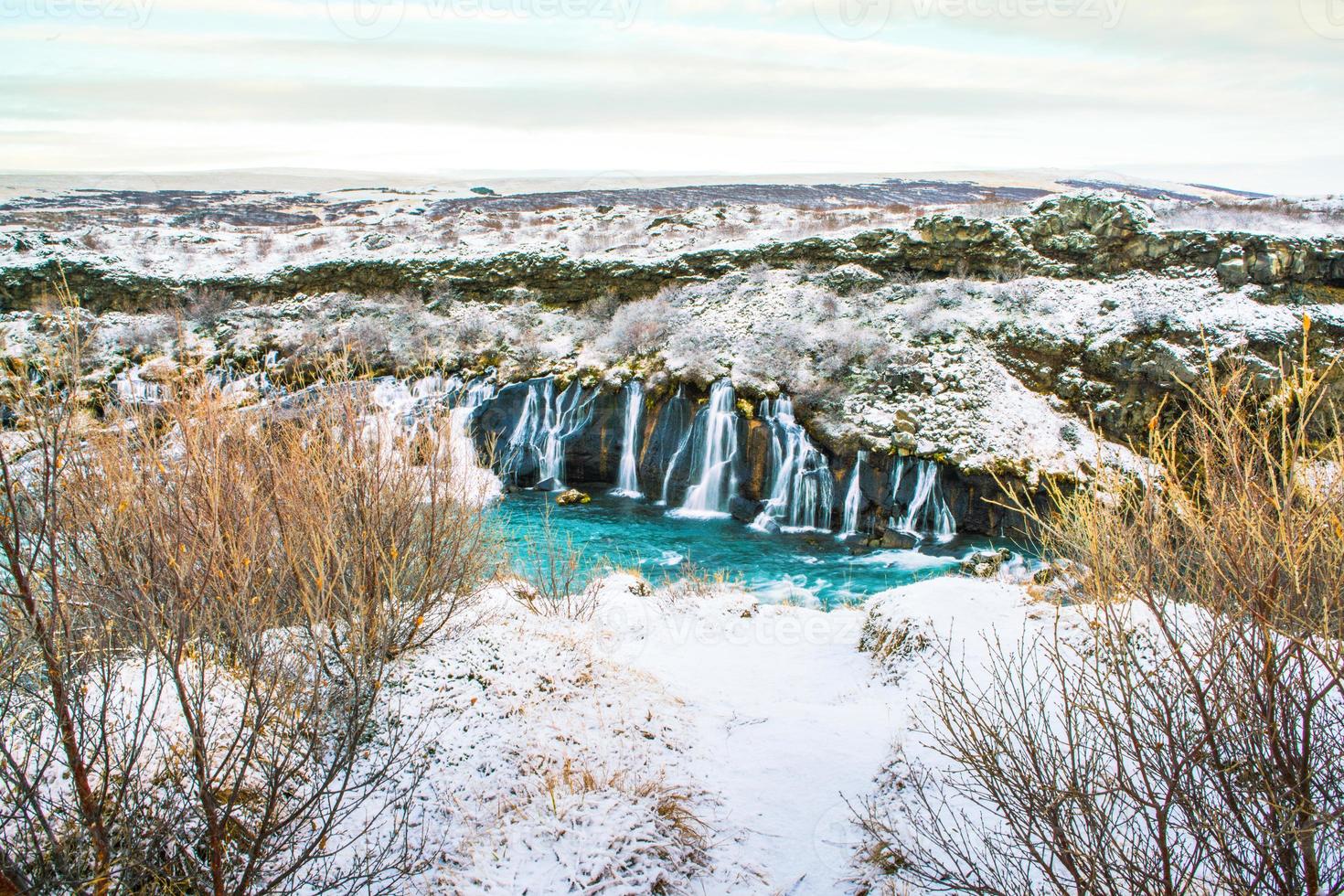 Hraunfossar, a waterfall formed by rivulets streaming over Hallmundarhraun, a lava field from volcano lying under the glacier Langjokull, and pour into the Hvita river, Iceland photo