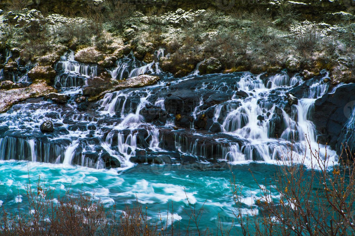 Hraunfossar, a waterfall formed by rivulets streaming over Hallmundarhraun, a lava field from volcano lying under the glacier Langjokull, and pour into the Hvita river, Iceland photo