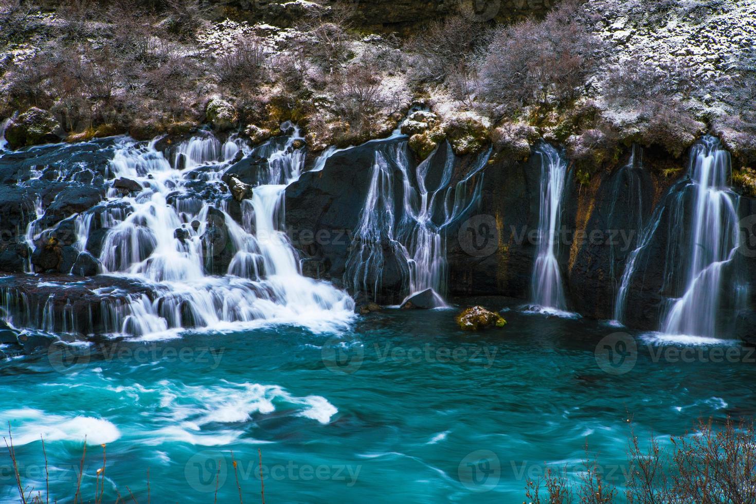 Hraunfossar, a waterfall formed by rivulets streaming over Hallmundarhraun, a lava field from volcano lying under the glacier Langjokull, and pour into the Hvita river, Iceland photo