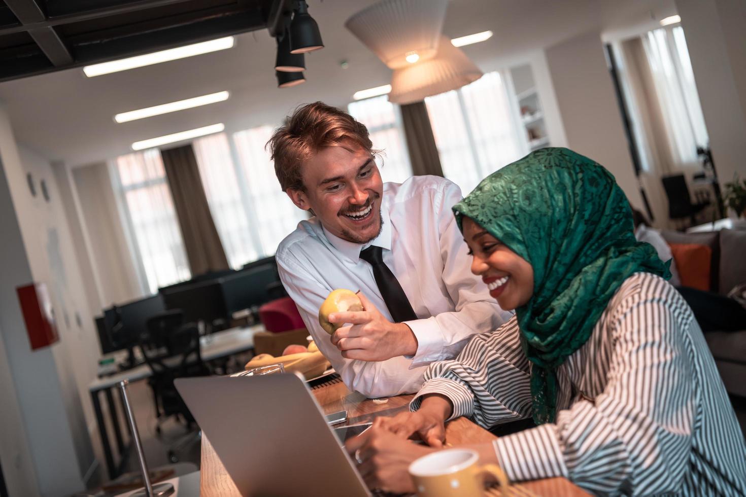 International multicultural business team.A young business man and woman sit in a modern relaxation space and talk about a new business. photo
