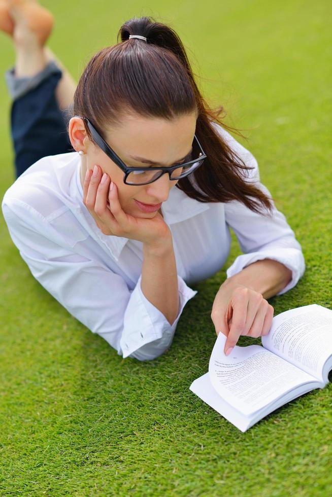Young woman reading a book in the park photo