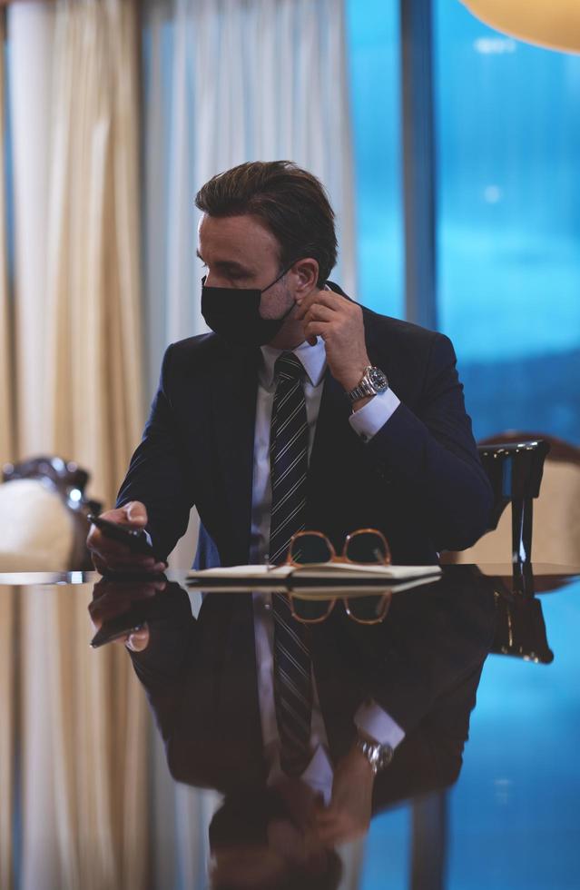 business man wearing protective face mask at office photo