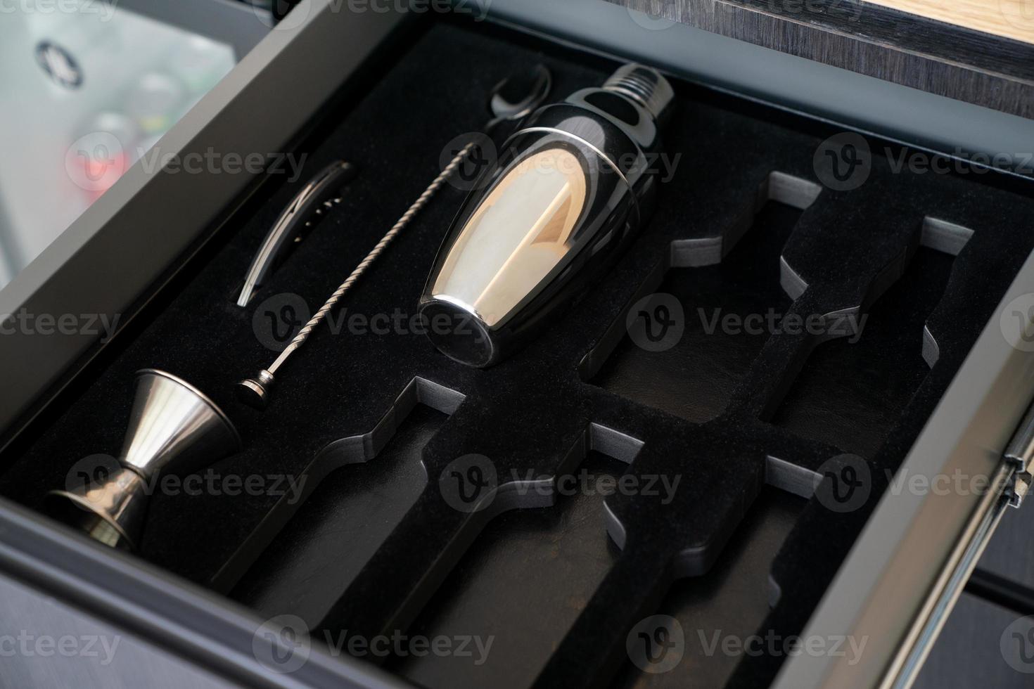 Bartender tools in wooden boxes. shaker and tableware in the drawer. Bartender equipment. photo