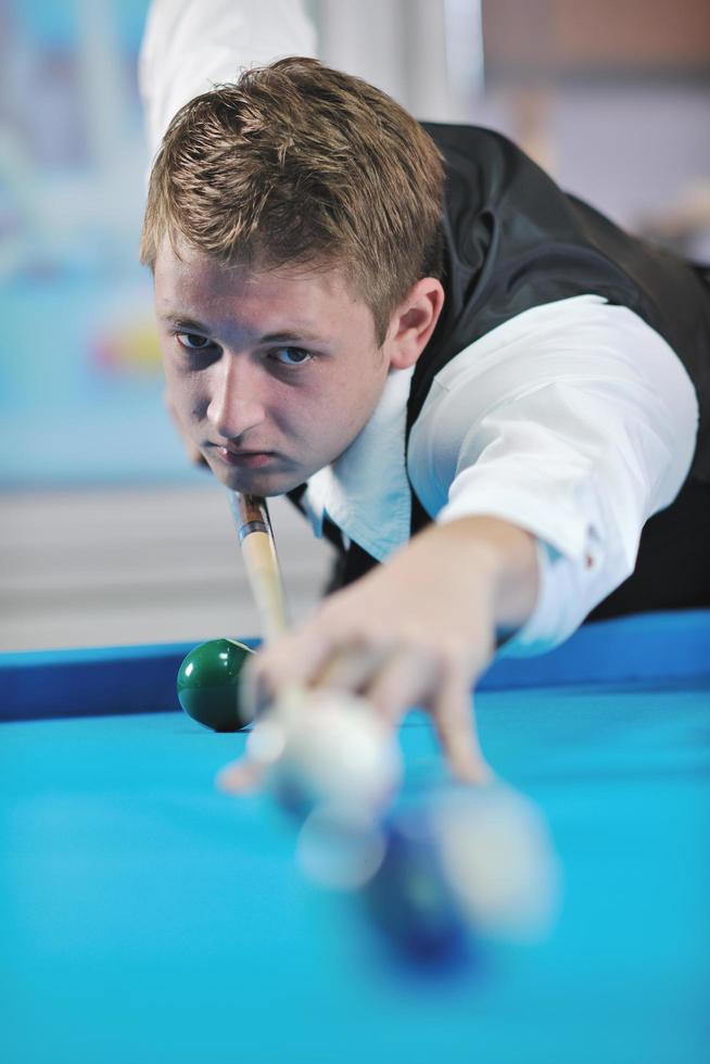 young man play pro billiard game photo