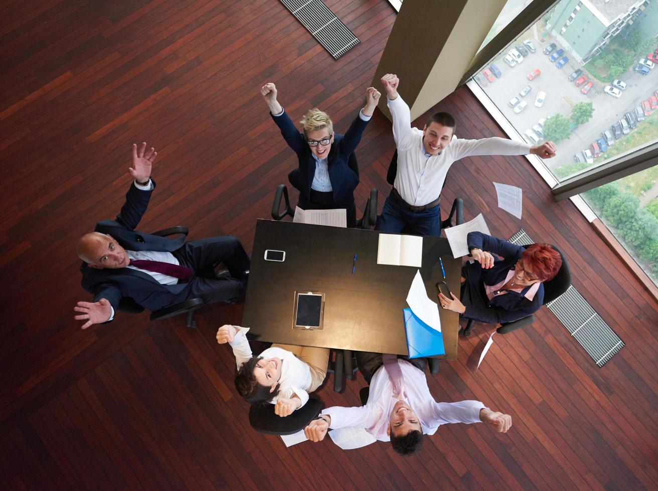 top view of business people group throwing dociments in air photo