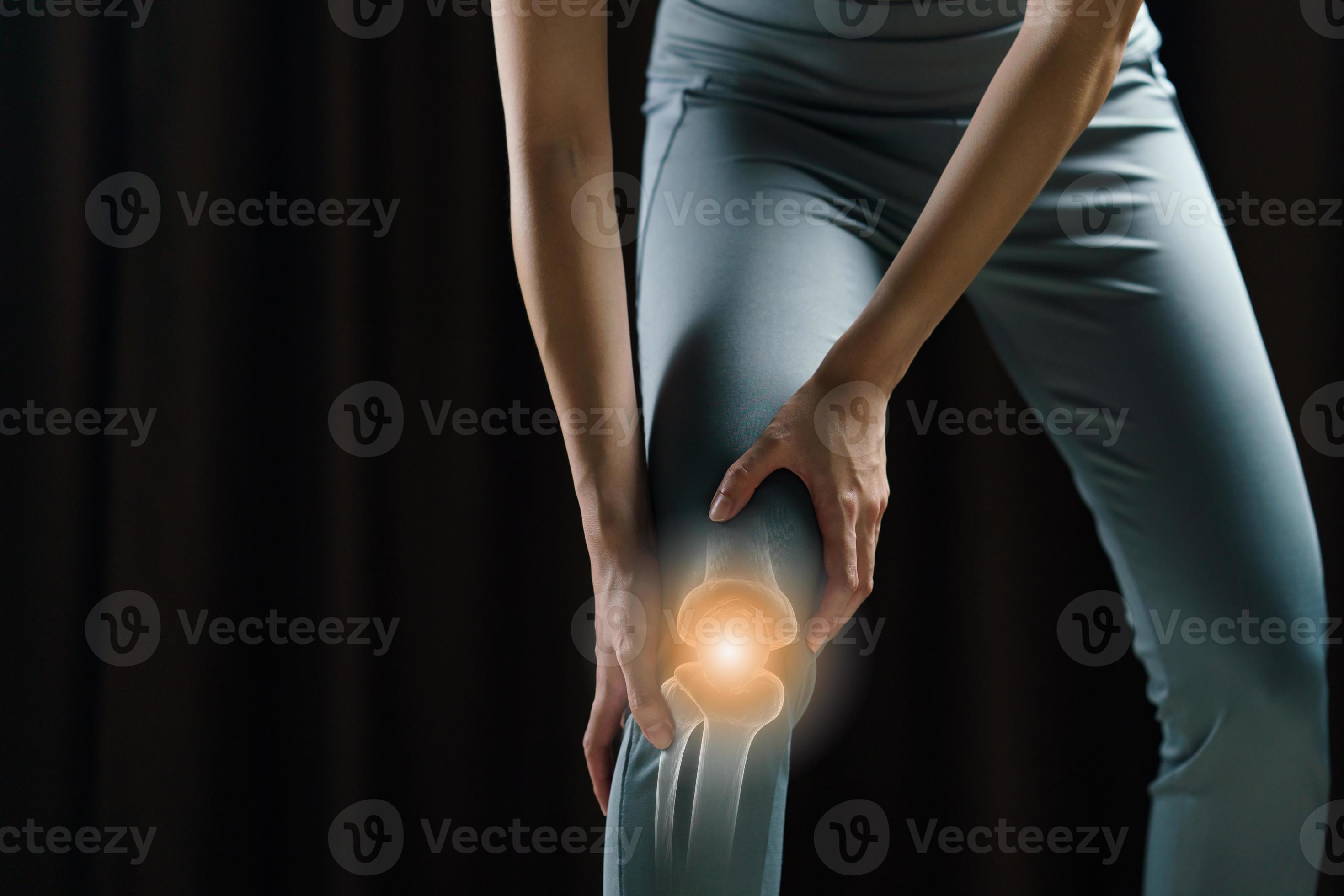 Woman holds her hands to the knee, pain in the knee highlighted in red