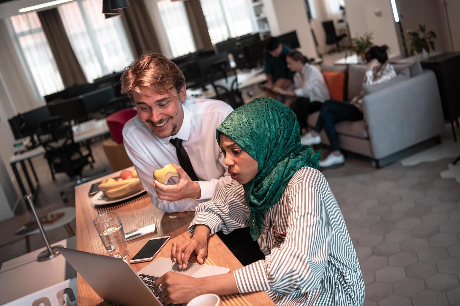 International multicultural business team.A young business man and woman sit in a modern relaxation space and talk about a new business. photo