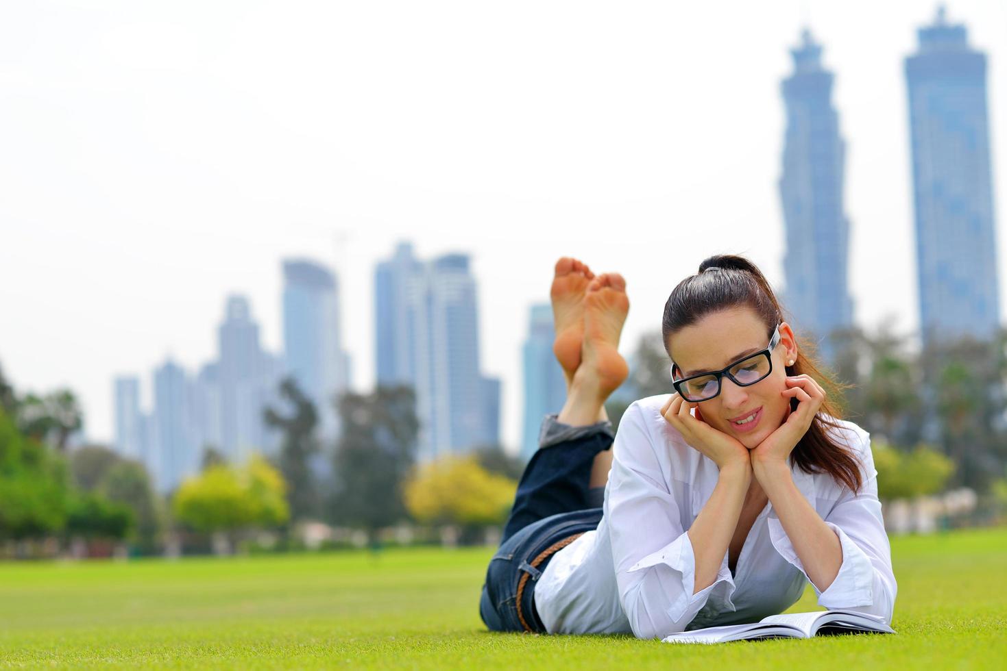 Young woman reading a book in the park photo