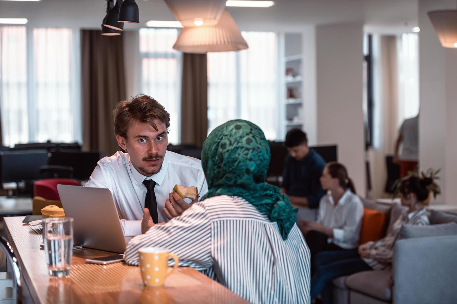 International multicultural business team.A young business man and woman sit in a modern relaxation space and talk about a new business. photo