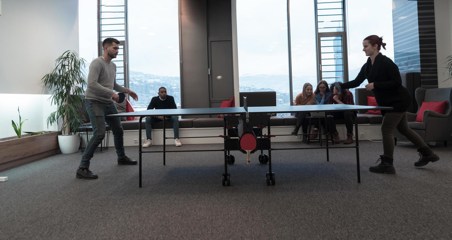 Young start up business man and woman playing table tennis at modern  creative office space people group have meeting and brainstorming in  background 12489602 Stock Photo at Vecteezy