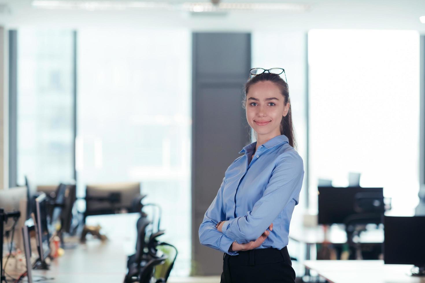 Portrait of freelancer standing in co-working space. Confident businesswoman looking at camera. photo