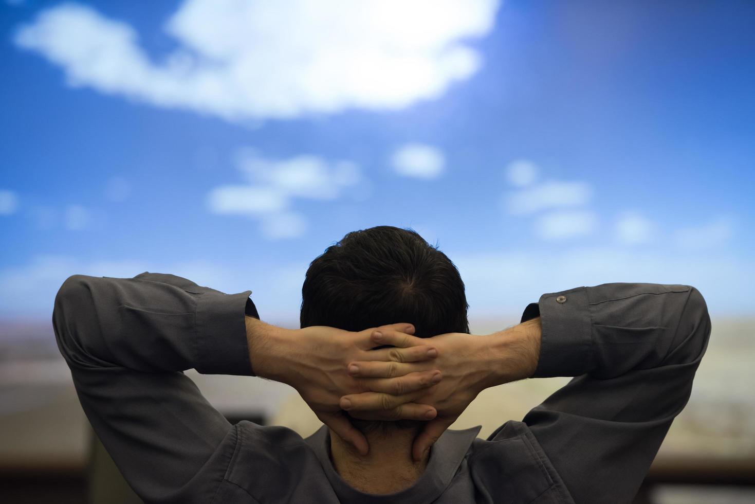 young man dreaming clouds on presentation photo