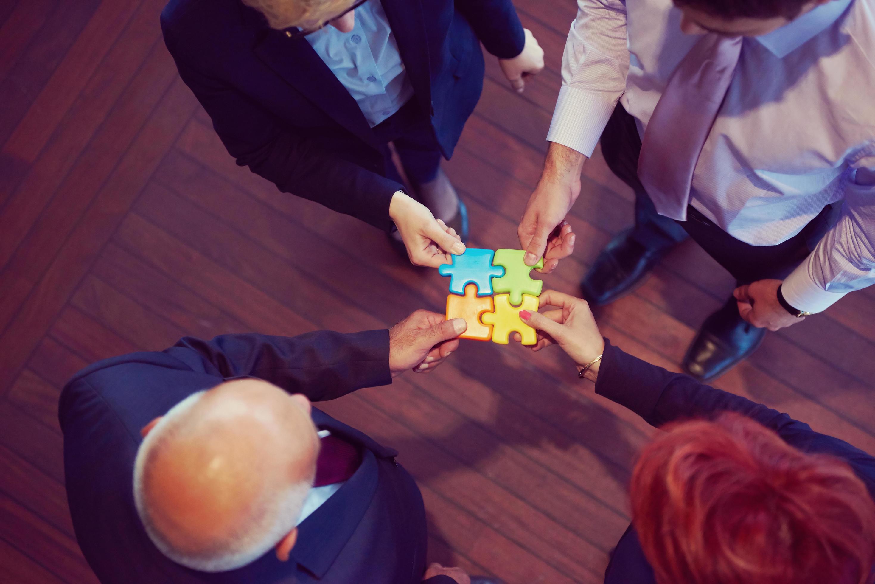 assembling jigsaw puzzle 12490880 Stock Photo at Vecteezy