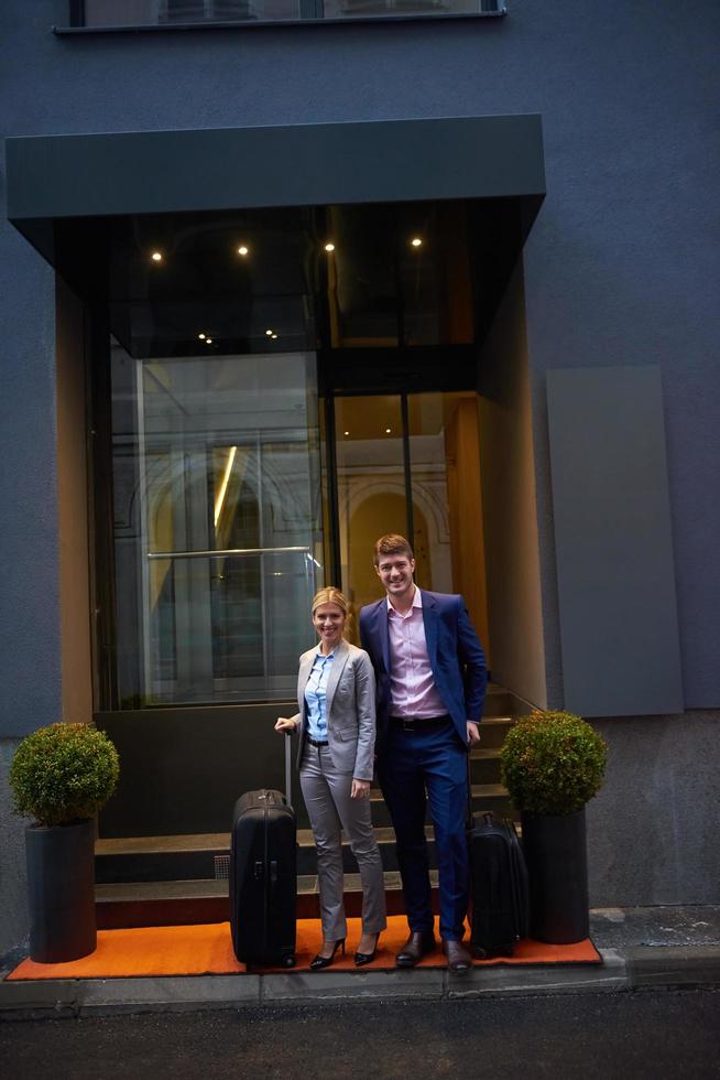 business people couple entering  hotel photo