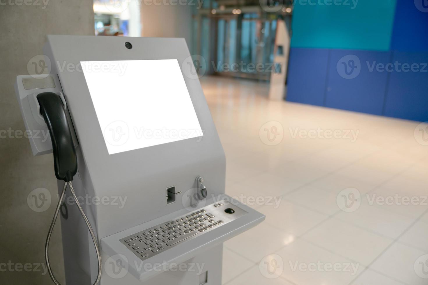 Automated information machine with mock up white screen in airport. photo