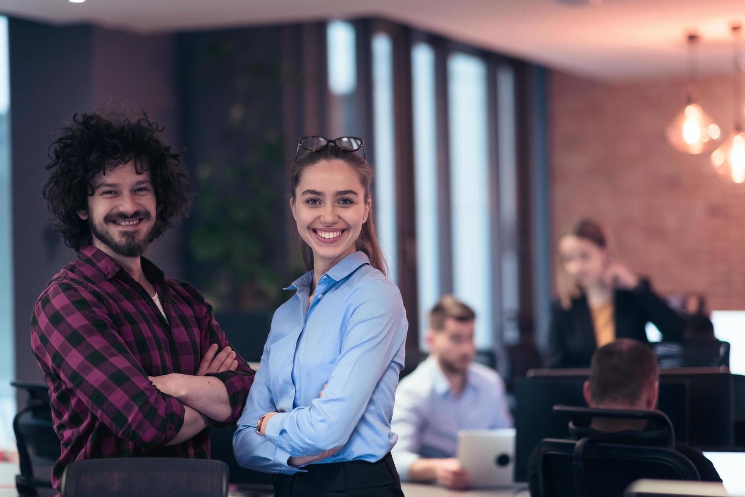 Two happy diverse professional executive business team people woman and man looking at camera standing in office lobby hall. Multicultural company managers team portrait. photo