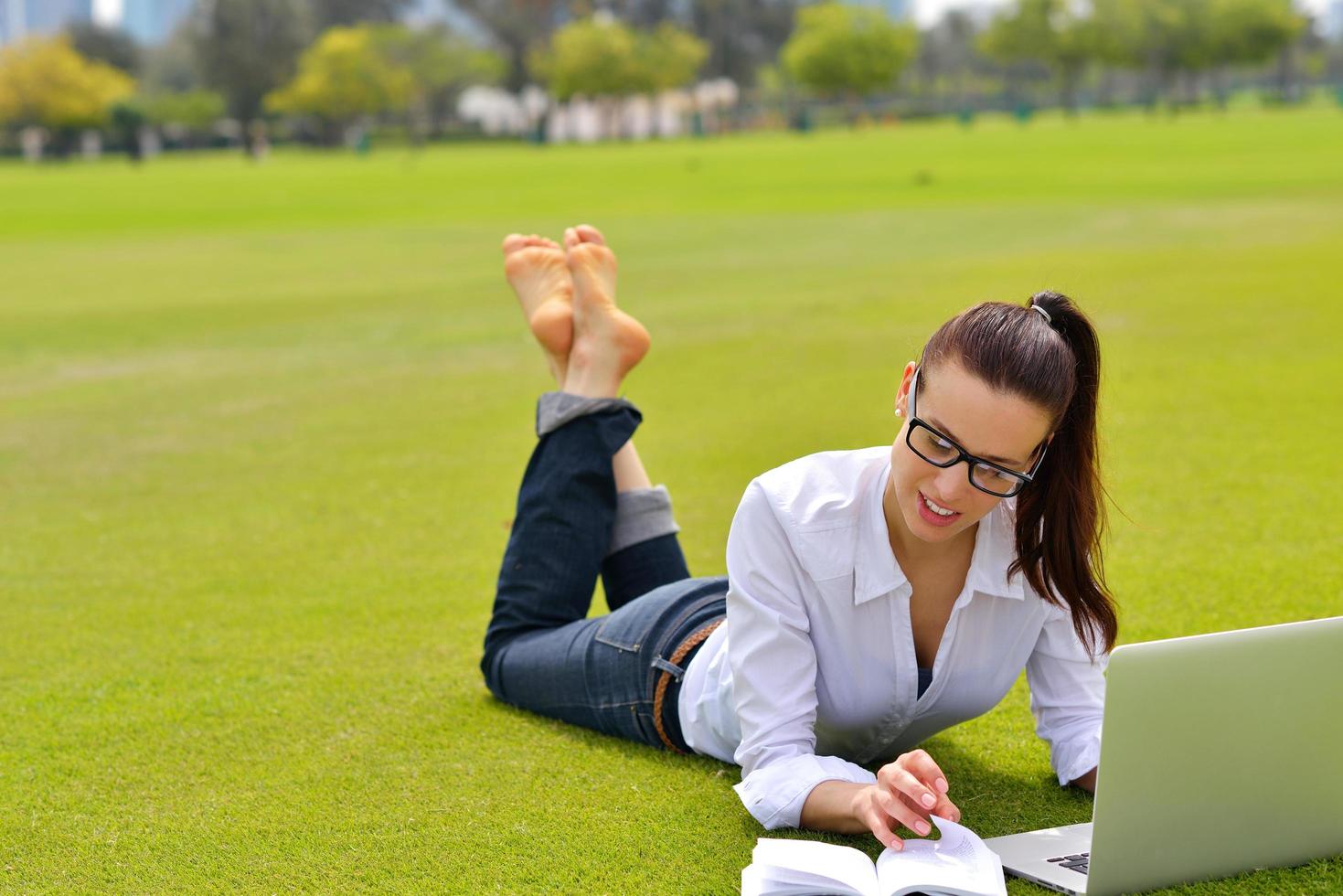 woman with laptop in park photo