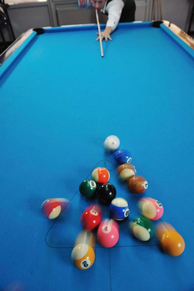 young man play pro billiard game photo