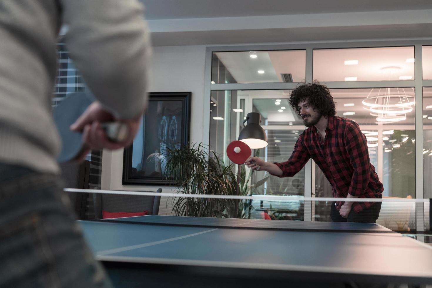 Two young start up business man playing ping pong tennis at modern creative  office space people group have meeting and brainstorming in background  12492172 Stock Photo at Vecteezy