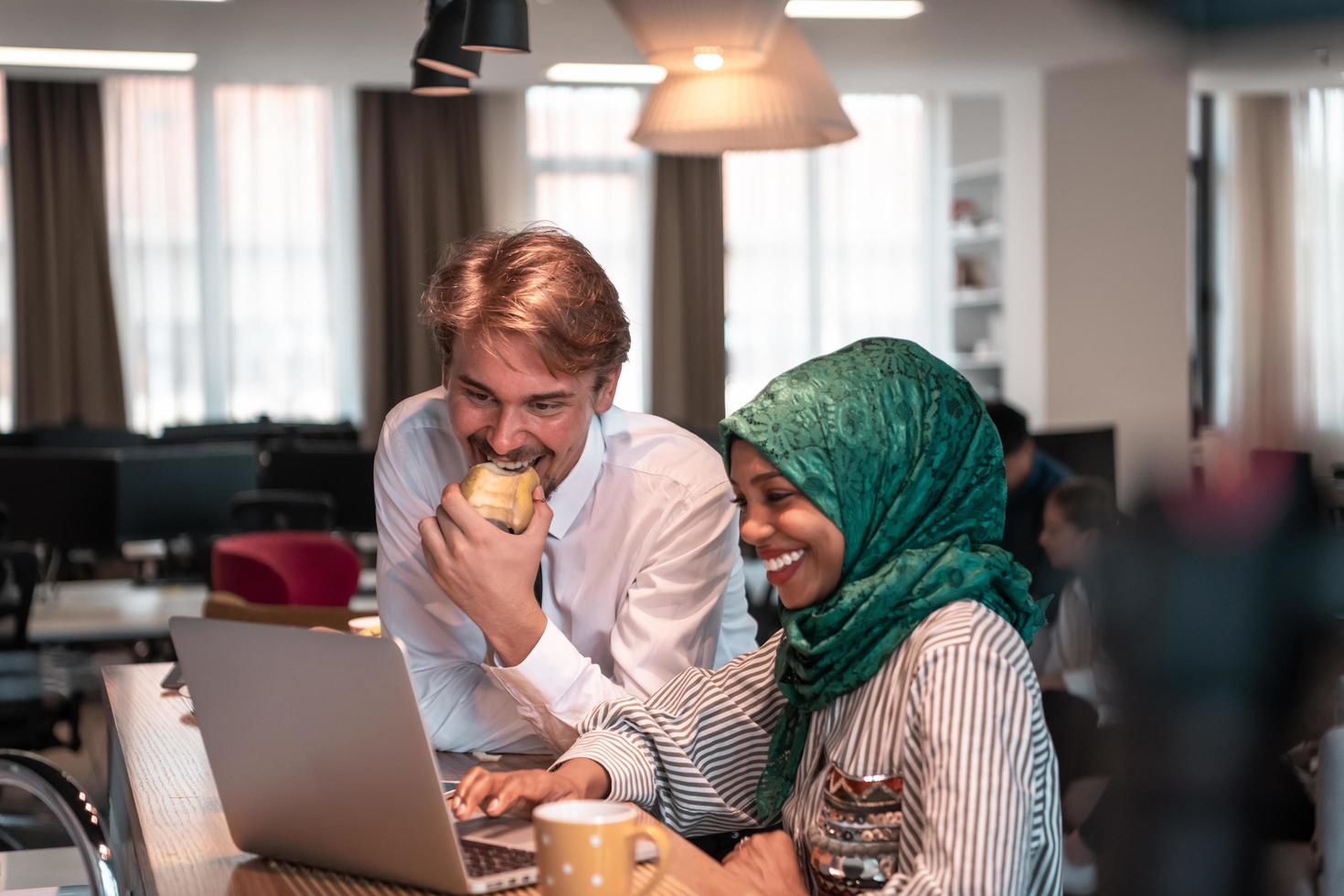 International multicultural business team.A young business man and woman sit in a modern relaxation space and talk about a new business. photo